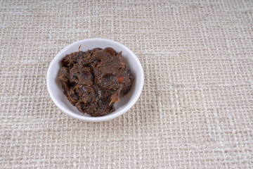 Tamarind paste on small bowl.