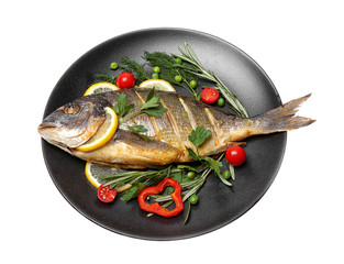 Tasty fish with vegetables on plate on white background