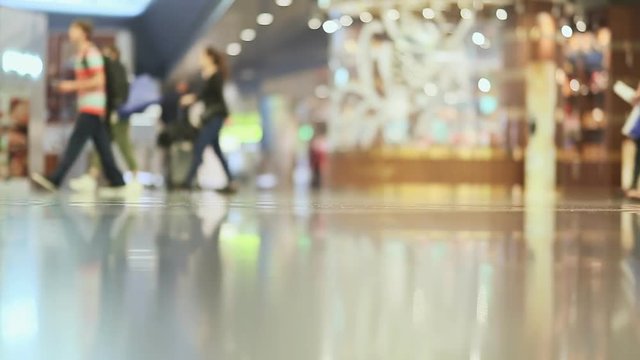 Passengers dragged baggage walking on the way at airport. Only legs view 1.