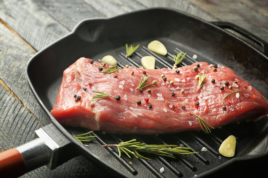 Delicious steak with aromatic rosemary and garlic in grill pan