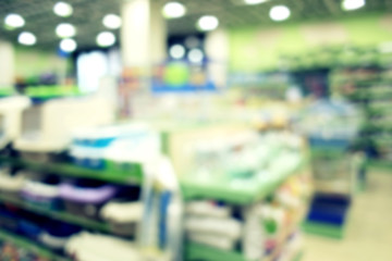 Blurred view of different animal goods on pet shop shelves