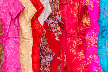 Closeup to some part of Chinese colorful flower dress or cloth of girls or women for background texture.