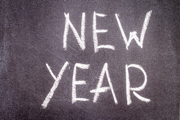 New year written with chalk on a black background