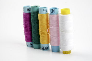 Sewing colored threads isolated on white background