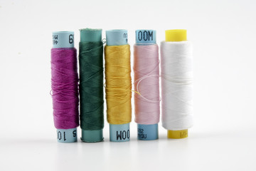 Sewing colored threads isolated on white background