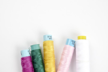 Sewing colored threads isolated on white background