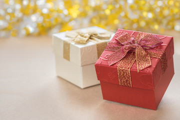 Gift box with ribbon and bokeh in background