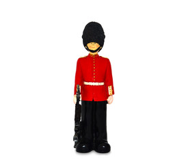 Queen's guard statue in traditional uniform with weapon, British soldier, isolated on white background