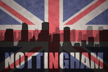 abstract silhouette of the city with text Nottingham at the vintage british flag