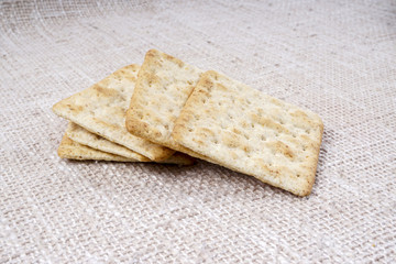 the cream cracker biscuit on the wooden background.