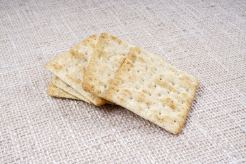 the cream cracker biscuit on the wooden background.