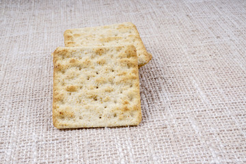 the cream cracker biscuit on the wooden background.