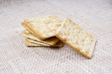 the cream cracker biscuit on the wooden background.