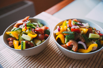 Fresh vegetable salad with olive oil, top view.