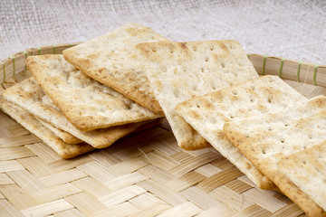 the cream cracker biscuit on the wooden background.