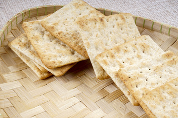 the cream cracker biscuit on the wooden background.