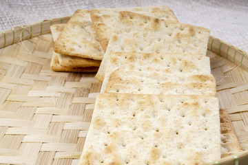 the cream cracker biscuit on the wooden background.