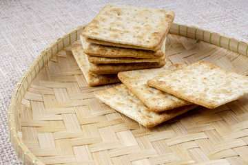 the cream cracker biscuit on the wooden background.