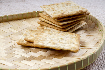 the cream cracker biscuit on the wooden background.