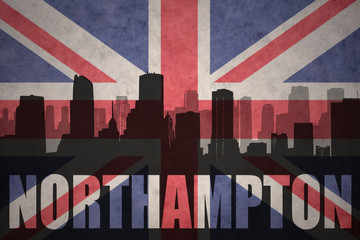 abstract silhouette of the city with text Northampton at the vintage british flag