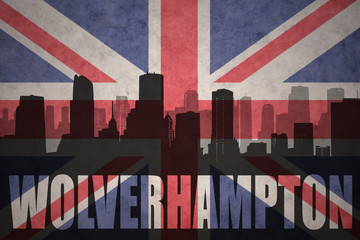 abstract silhouette of the city with text Wolverhampton at the vintage british flag