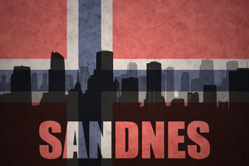 abstract silhouette of the city with text Sandnes at the vintage norwegian flag
