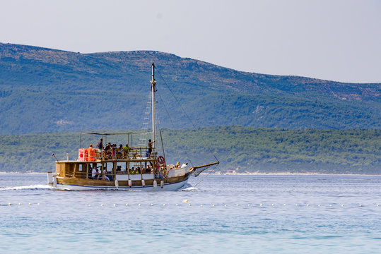 Tourist boat taking guests on sightseeing island tour in Adriati
