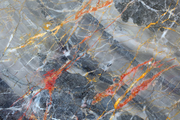 Gold, red and white patterned in dark gray marble texture