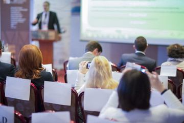 Expressive Lecturer at the Conference Speaking to the Group of Business People At the Conference