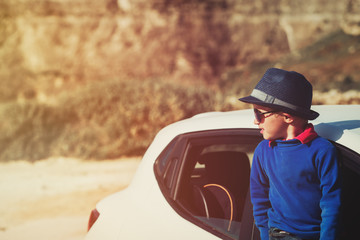 little boy travel by car in nature