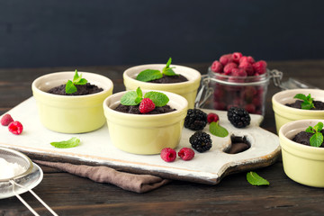 Chocolate cakes with berries and mint leaves