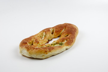 Fresh whole grain bread cut in half on white background