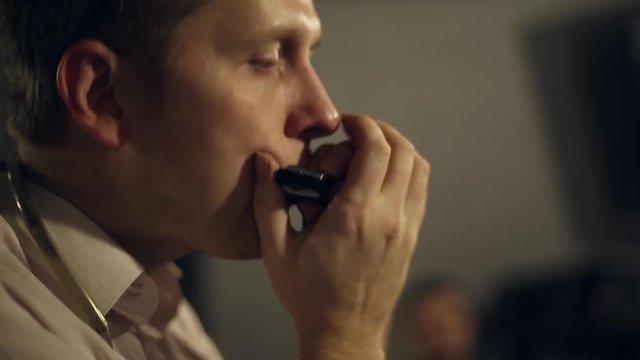 Musician plays the harmonica in the club
