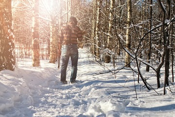 birch winter forest man with axe