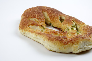 Fresh whole grain bread cut in half on white background