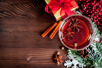 cup with christmas mulled wine on wooden background top view