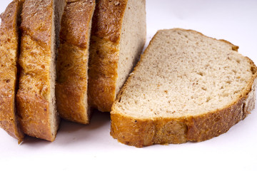 Fresh whole grain bread cut in half on white background