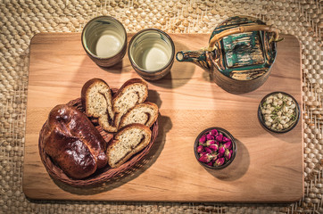 Tea drinking ceremony. Flower tea with jasmine and rose buds and delicious home made pastry.