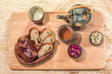 Tea drinking ceremony. Flower tea with jasmine and rose buds and delicious home made pastry.