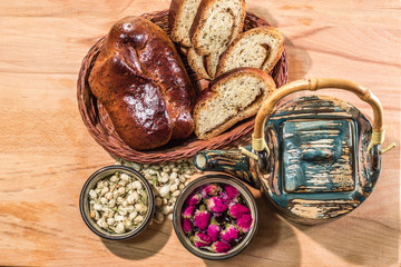 Tea drinking ceremony. Flower tea with jasmine and rose buds and delicious home made pastry.