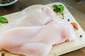 Raw chicken  with garlic on  wooden background