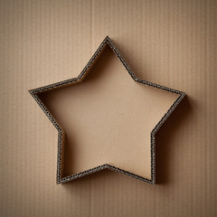 Christmas gift box in the shape of a star on a cardboard background