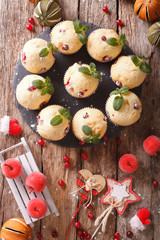 Christmas cranberry muffins decorated with mint closeup. vertical top view