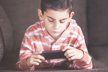 Young boy using a smartphone at home