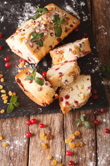 Delicious Sliced fruit cake with cranberries and raisins decorated with mint closeup. vertical