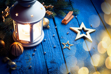Christmas lantern in night on old wooden background