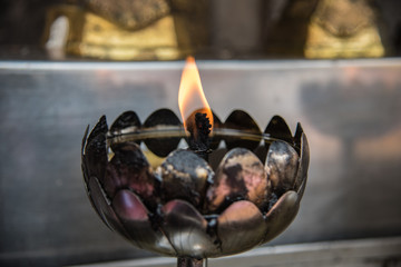 Fire on candle in temple 