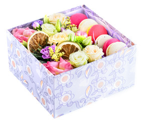 Box with fresh flowers and macaroons, isolated on white