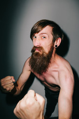 Portrait of a bearded man bringing his fists up