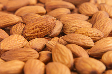 Almonds background. Pile of selected almonds close-up. For vegetarians.